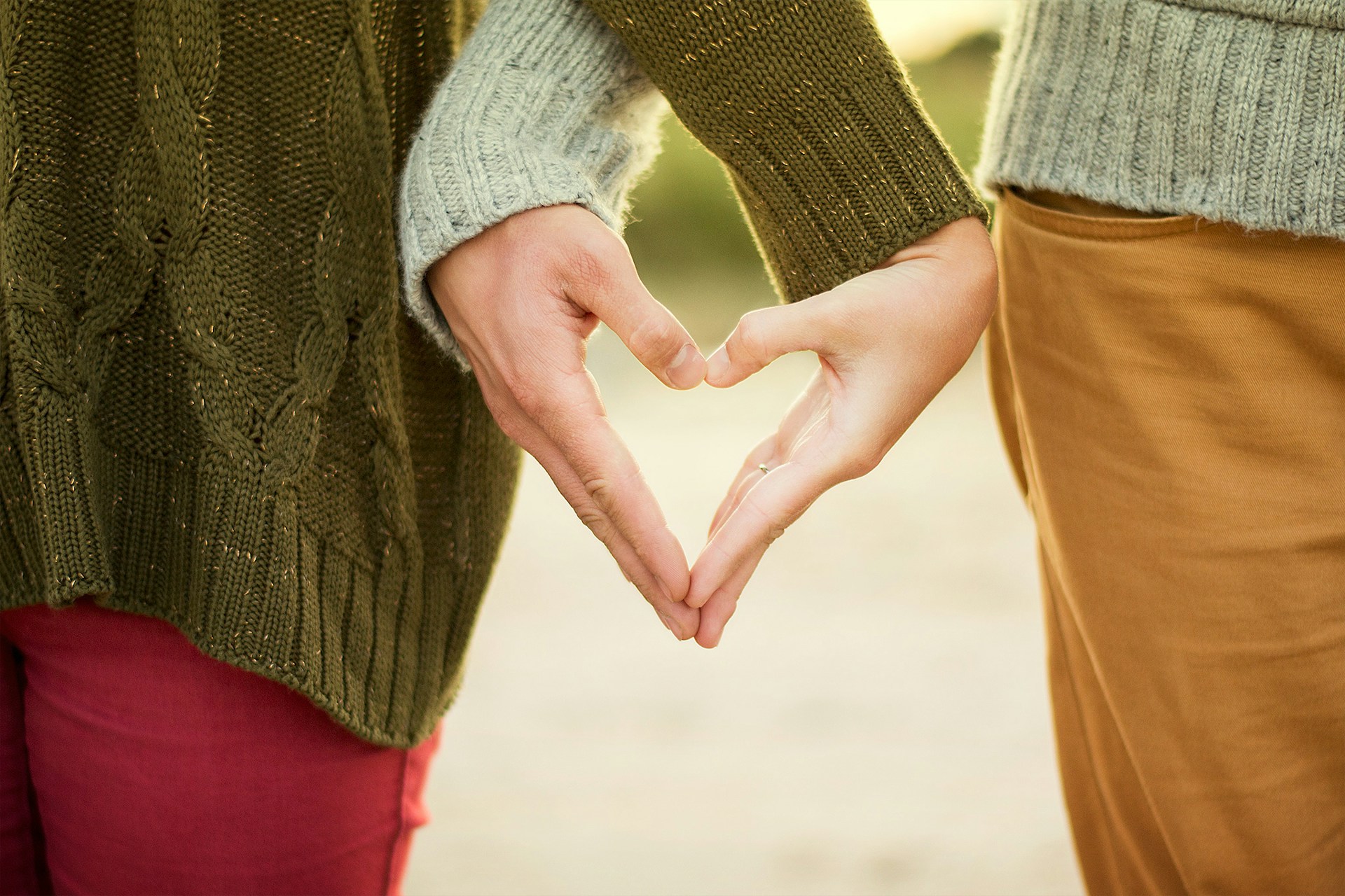 romantic hand holding in heart shape